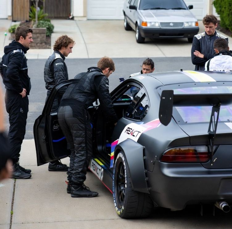crew inspecting racing car